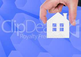 Composite image of Hand Holding House icon against blue background