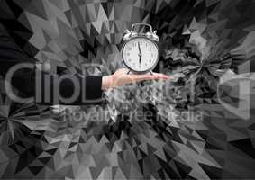 Composite image of business woman hand holding clock against graphic dark background