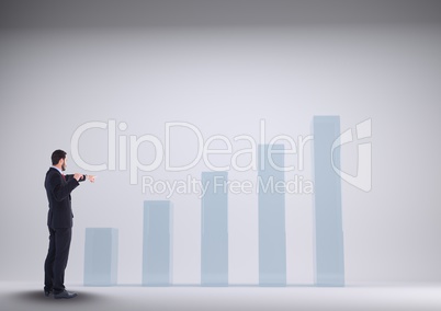 Businessman Standing looking at Graphic against a grey background