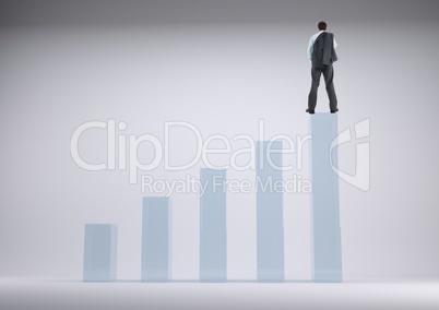 Businessman standing on a graph against a grey background