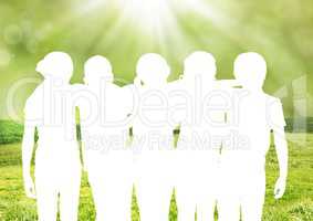 Composite of silhouette of a group of friends against green background
