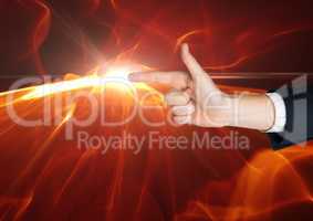 Composite image of Hand as a gun with a flame at the top of the finger against black background