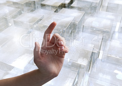 Composite image of Hand pointing glass cubes