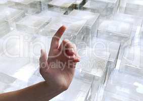 Composite image of Hand pointing glass cubes