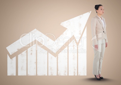 Businesswoman standing in front of graph against a neutral background