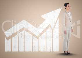 Businesswoman standing in front of graph against a neutral background