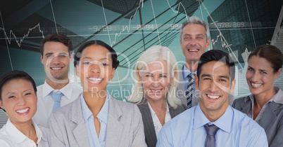 Business Team Smiling and Standing in front of Graph against blue background