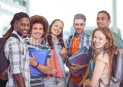 Students group smiling at camera against a light background