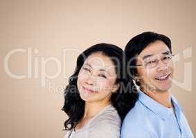 Happy Couple smiling against a neutral background