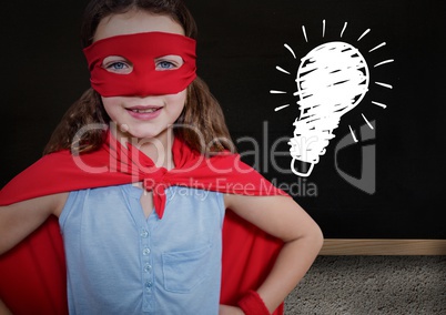 kid and blackboard with lightbulb against a black background