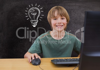 Composite image of kid in front of a computer against blackboard with lightbulb