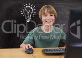 Composite image of kid in front of a computer against blackboard with lightbulb