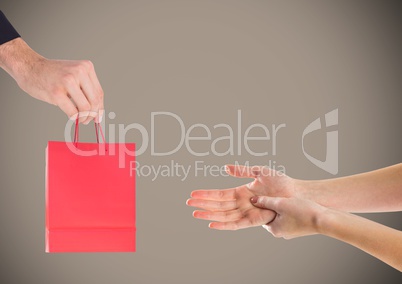Composite image of Hands offering Gift against grey background