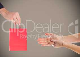 Composite image of Hands offering Gift against grey background