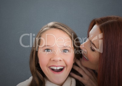 Mother and Daughter Smilling against a grey background