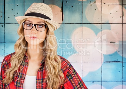 Woman in fedora against tiles with bokeh background