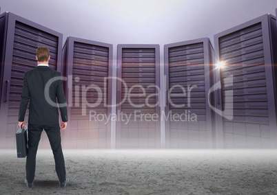 Businessman Standing looking at Graphic against a dark grey background
