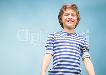 Kid Boy smiling at camera against blue background