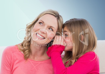 Mother and Daughter Smilling against a neutral background