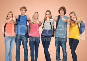 Group of Happy Students againt smiling and raising their thumb at camera agaisnt a orange background