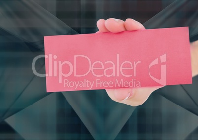 Composite image of Hand Holding pink Card against dark background
