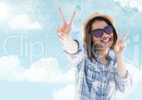 Woman with sunglasses smiling against sky with flare background