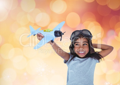 Happy Kid Boy Playing with toy against a shining orange background