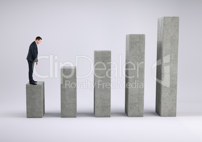 Businessman standing on a graph against a grey background