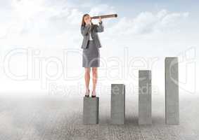 Business woman on a graph looking her objectives against sky background