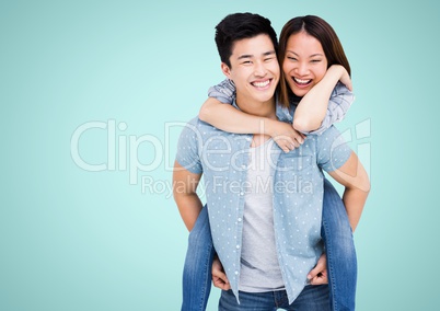 Composite image of happy Asian couple against blue background