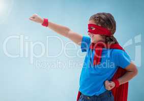 Composite image of superhero boy against blue background