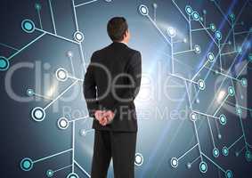 Composite image of Businessman Standing and looking at Graphic