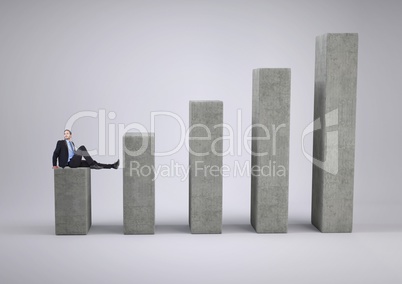 Businessman seating on graph against a grey background