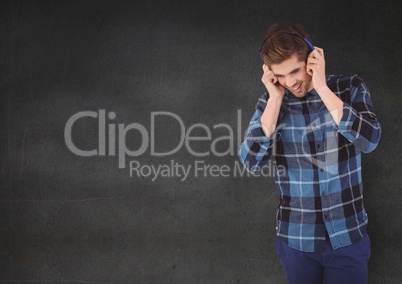 Man with headphones against grey background