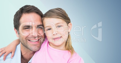 Father and his daughter smiling at camera against a blue background