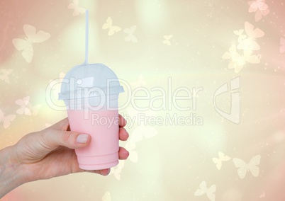Composite image of Hand holding Milkshake Smoothie against Butterflies background