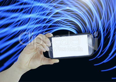 Composite image of Hand holding cell Phone against light effects