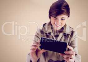 Woman using Phone against a neutral background