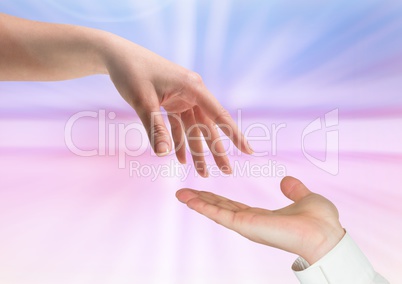 Composite of two hands against a colorful background