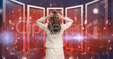 Businesswoman Standing holding her head and looking at Graphic against red background