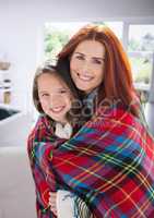 Mother and Daughter Hugging against a home background