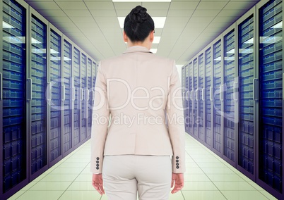 Composite image of Business woman back view standing in a corridor