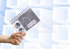 Composite image of Hand holding Statistics charts notepad against modern white background