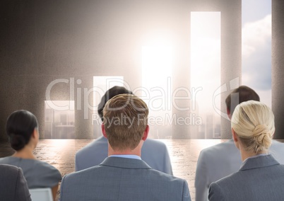 Business Group Standing in front of Graph against a neutral background