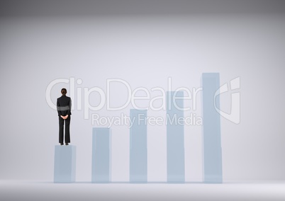 Businesswoman standing on graph against grey background