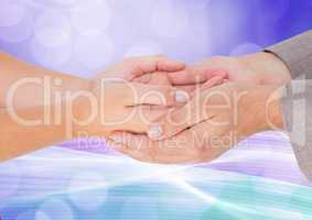 Composite Image of two hands holding each others against colorful background