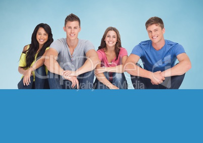 Happy Group of Teenagers smiling at canera against a Blue background