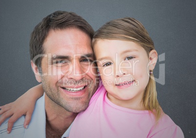 Father and his daughter smiling at camera against a grey background