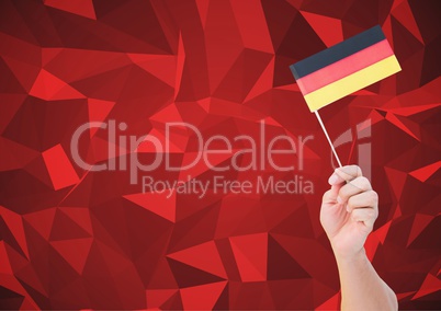 Composite image of hand holding German Flag against red Polygons background