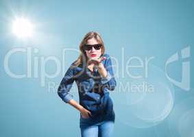 Composite image of Woman blowing kiss against blue background with flare